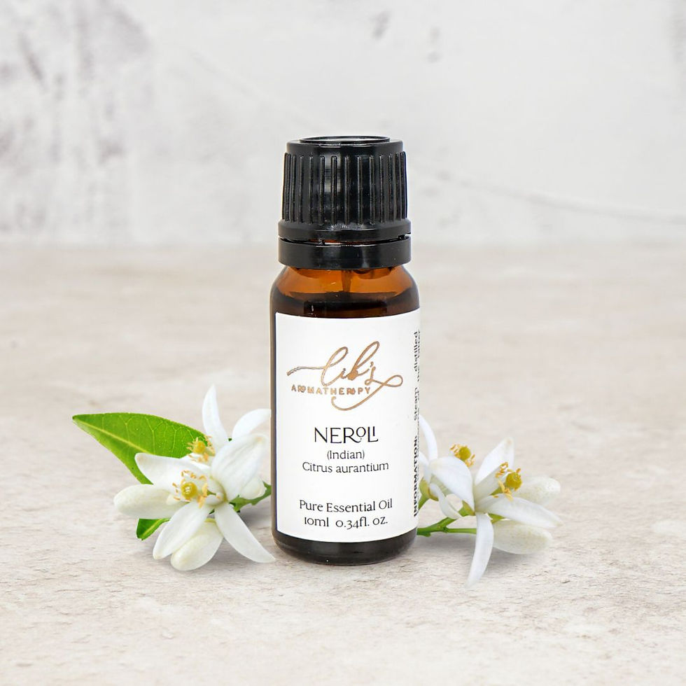 Natural Neroli essential oil bottle styled with delicate orange blossom flowers and green leaves on a soft neutral background