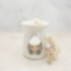 Oil burner with lit tealight and wax melts