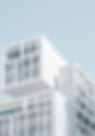 white multifamily apartment building with blue sky background