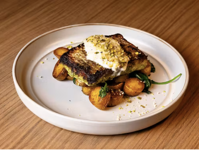 A beautifully plated gourmet seafood dish presented in a sophisticated Michelin-level restaurant setting.