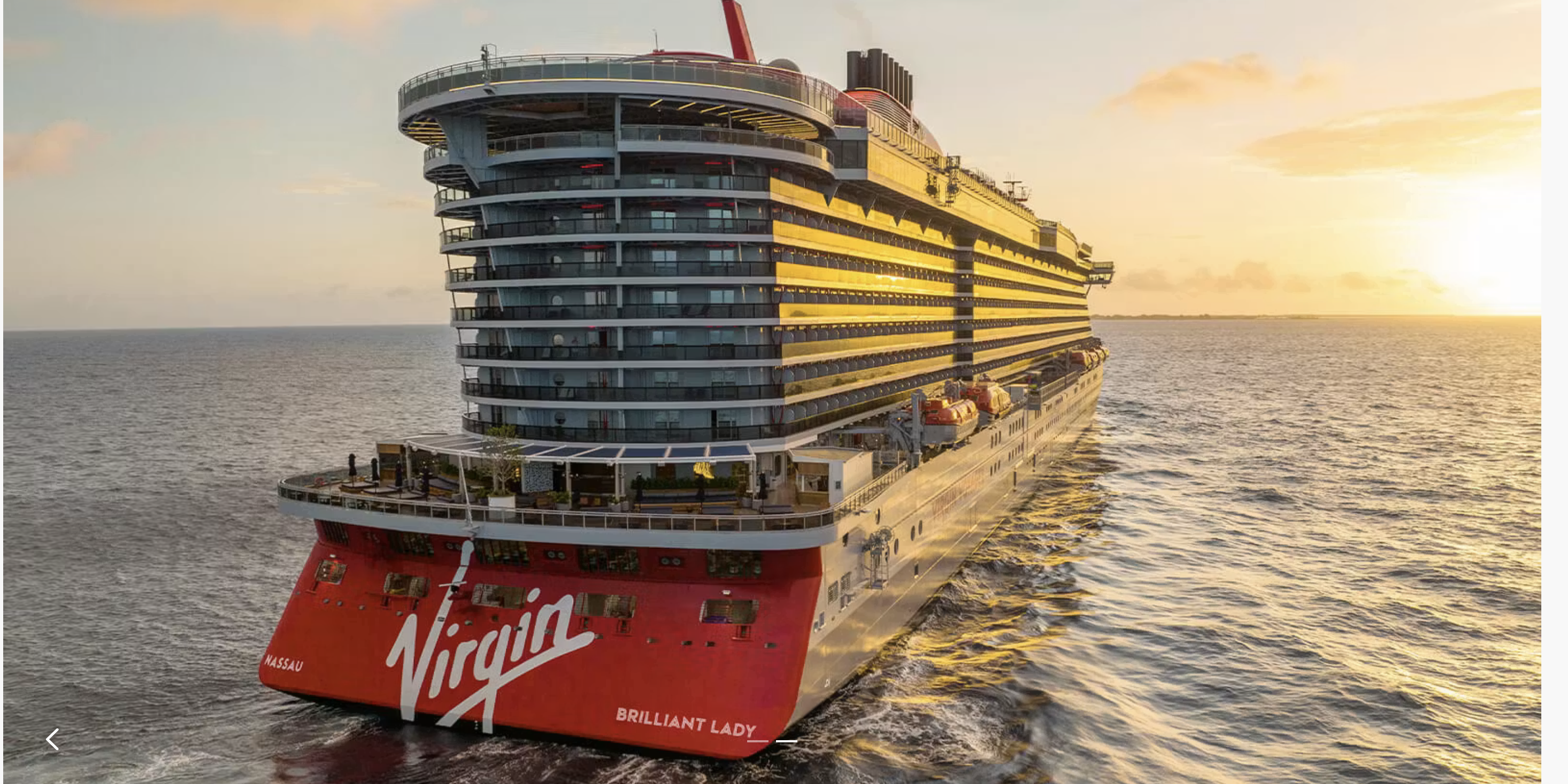 A modern luxury cruise ship sails gracefully through calm waters under a vibrant sunset sky.