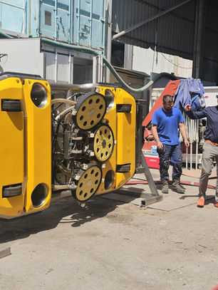 MaxiDive technical team reviewing robotic hull cleaning equipment in Dubai
