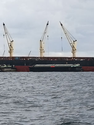 Commercial vessel at Koh Si Chang Anchorage during full hull cleaning and propeller polishing in Thailand