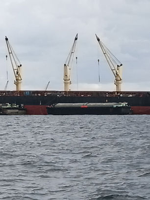 Commercial vessel at Koh Si Chang Anchorage during full hull cleaning and propeller polishing in Thailand