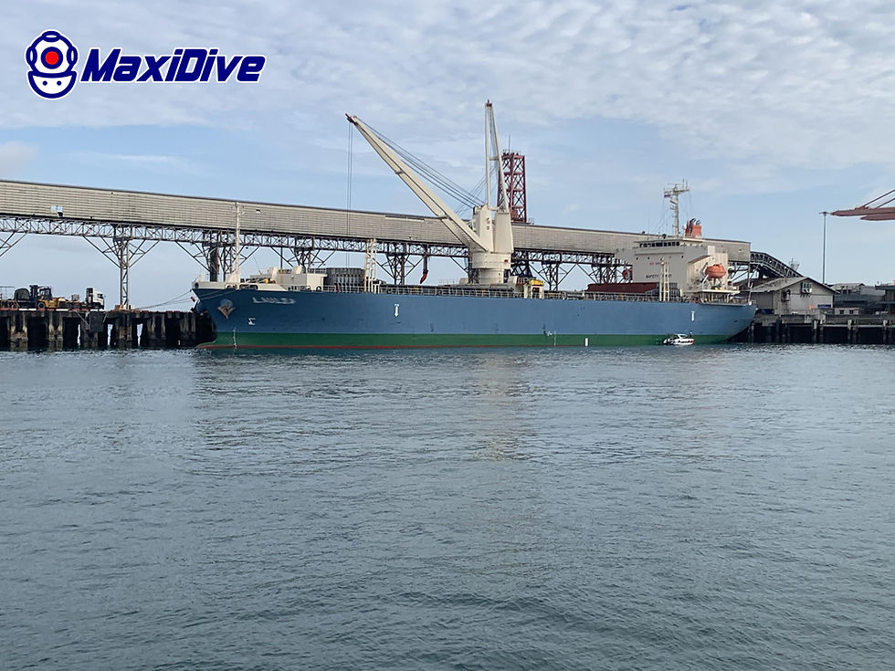 Commercial vessel alongside Kerry Siam Seaport before underwater hull cleaning and propeller polishing by MaxiDive