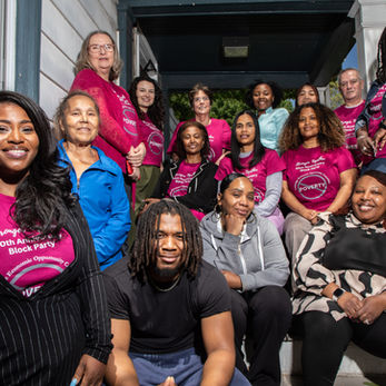 Group of CEOC staff sitting on the steps of the building