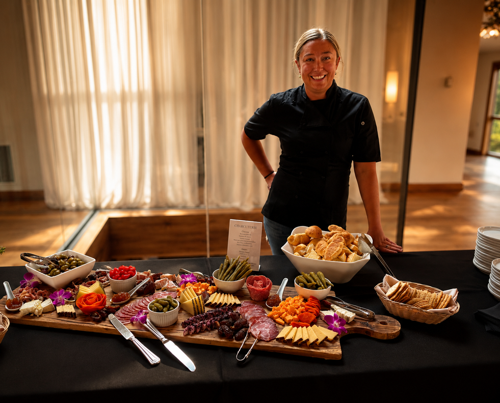 Chef Damon Renfroe and his partner Rachel serving a gourmet charcuterie display at a private event