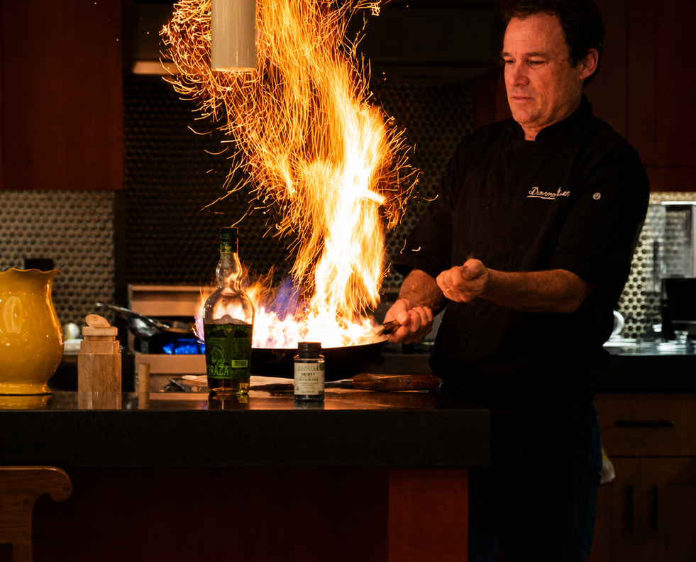 Chef Damon Renfroe creating a tableside flame presentation during a private dinner