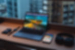 A picture of a laptop and a phone showing the website "Art University"