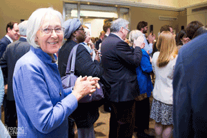 Woman in purple listening to speeches
