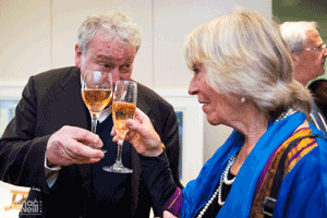 Man and woman clinking glasses