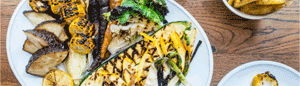 A large white plate holding a selection of charred vegetables