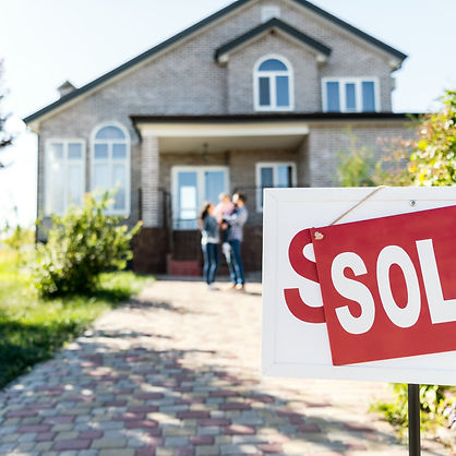 A sold sign sits in front of a nice home.