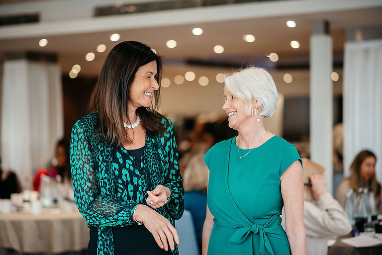 Co-founders of Health Coaches Academy Carolyn St John Loder and Ann Garry smiling at a student conference
