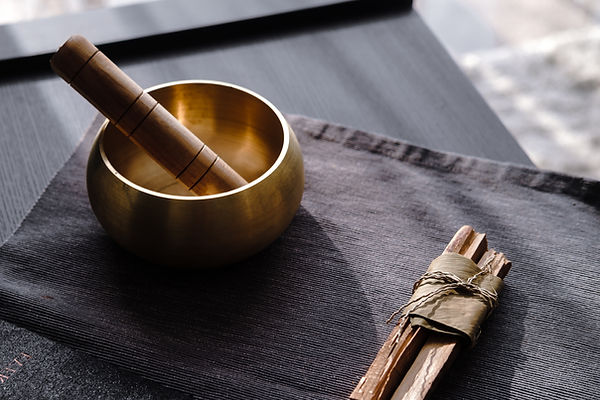 Bronze tibetan singing bowl with wooden stick, palo santo wood. Sound healing, sound bath