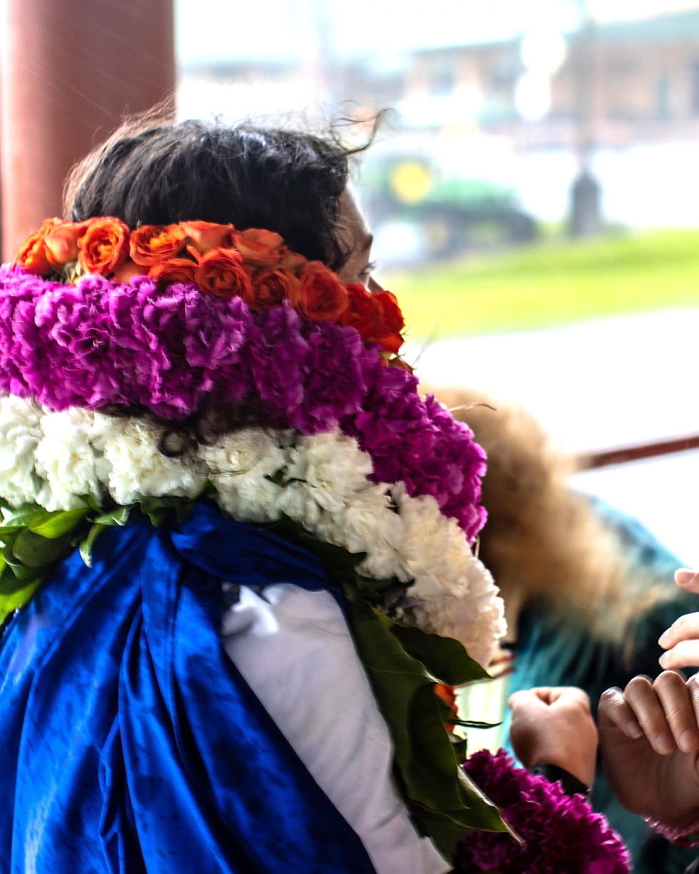 Close-up view of vibrant flower lei on a wooden table