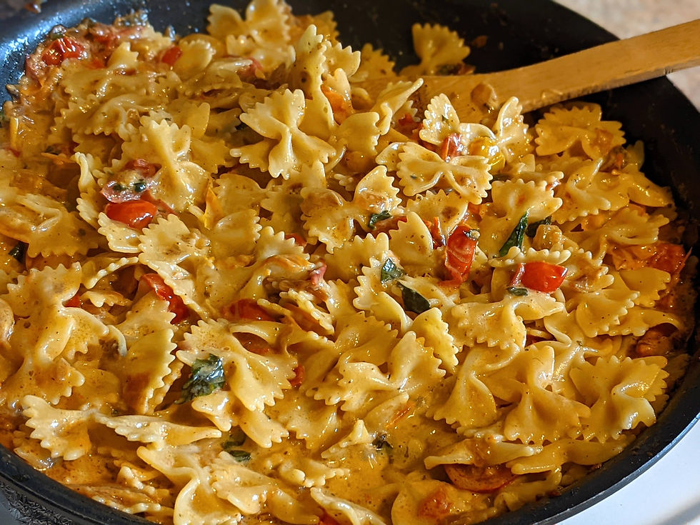 pan of farfalle pasta in tomato sauce