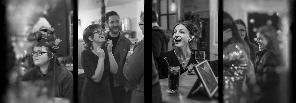 Black and white photo of laughing people at a social gathering