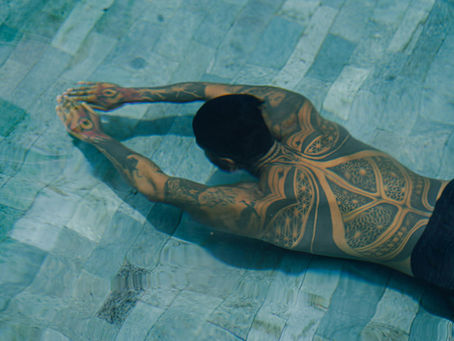 tattooed man swimming underwater full back tattoo aftercare avoid swimming fresh tattoo healing