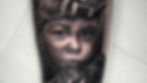 Tattoo of a child's face merging with a bear's head on skin. Detailed shading, intense expression, white paper background.