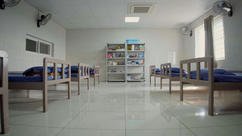 Clean room with beds and supplies on shelves, Campus Life at Future Kids Global School