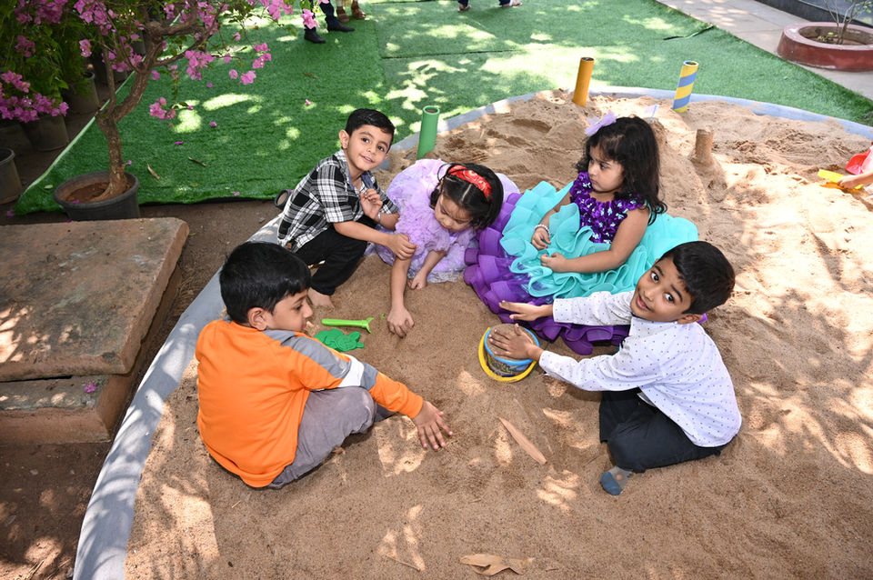 Children playing in sandbox, interacting and building together, Campus Life at Future Kids Global School.