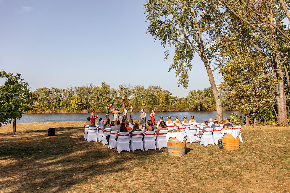 Outdoor wedding ceremony at Waverly Area Veterans Post in Waverly Iowa overlooking the Cedar River in fall