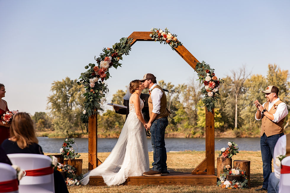 Outdoor wedding ceremony at Waverly Area Veterans Post in Waverly Iowa overlooking the Cedar River in fall