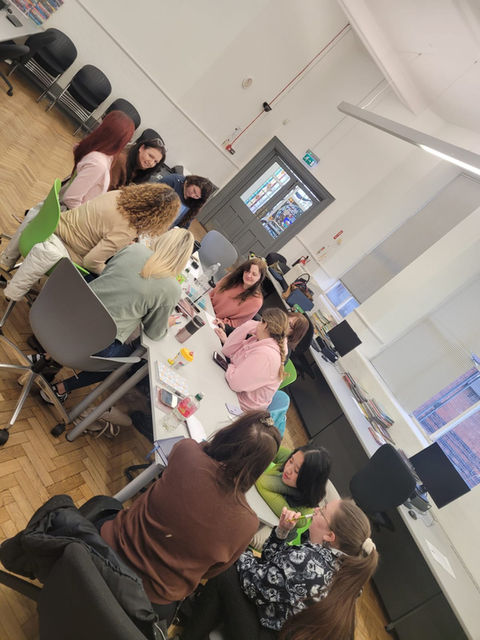 Group sitting around desk during Change Makers class