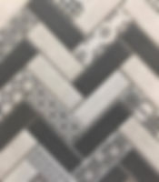 Interlocking rectangular tiles with a grey and white herringbone finish