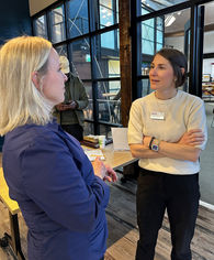 Two woman talking after a pitch and present event