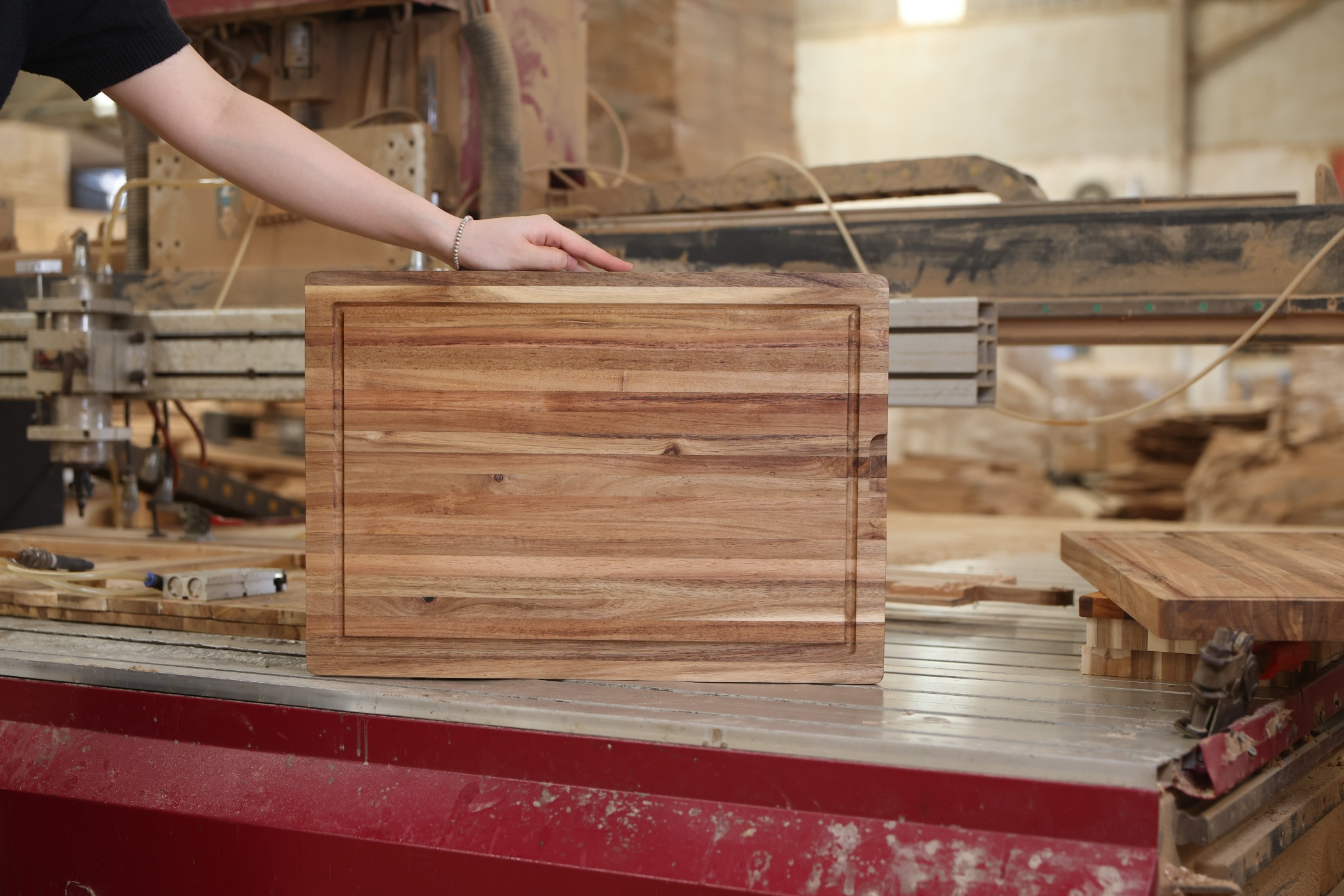 Rectangular acacia cutting board with rounded corners and a full perimeter juice groove, made in Vietnam