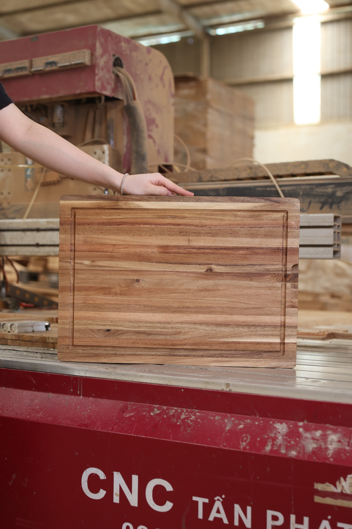 Rectangular cutting board presented at a factory machining table