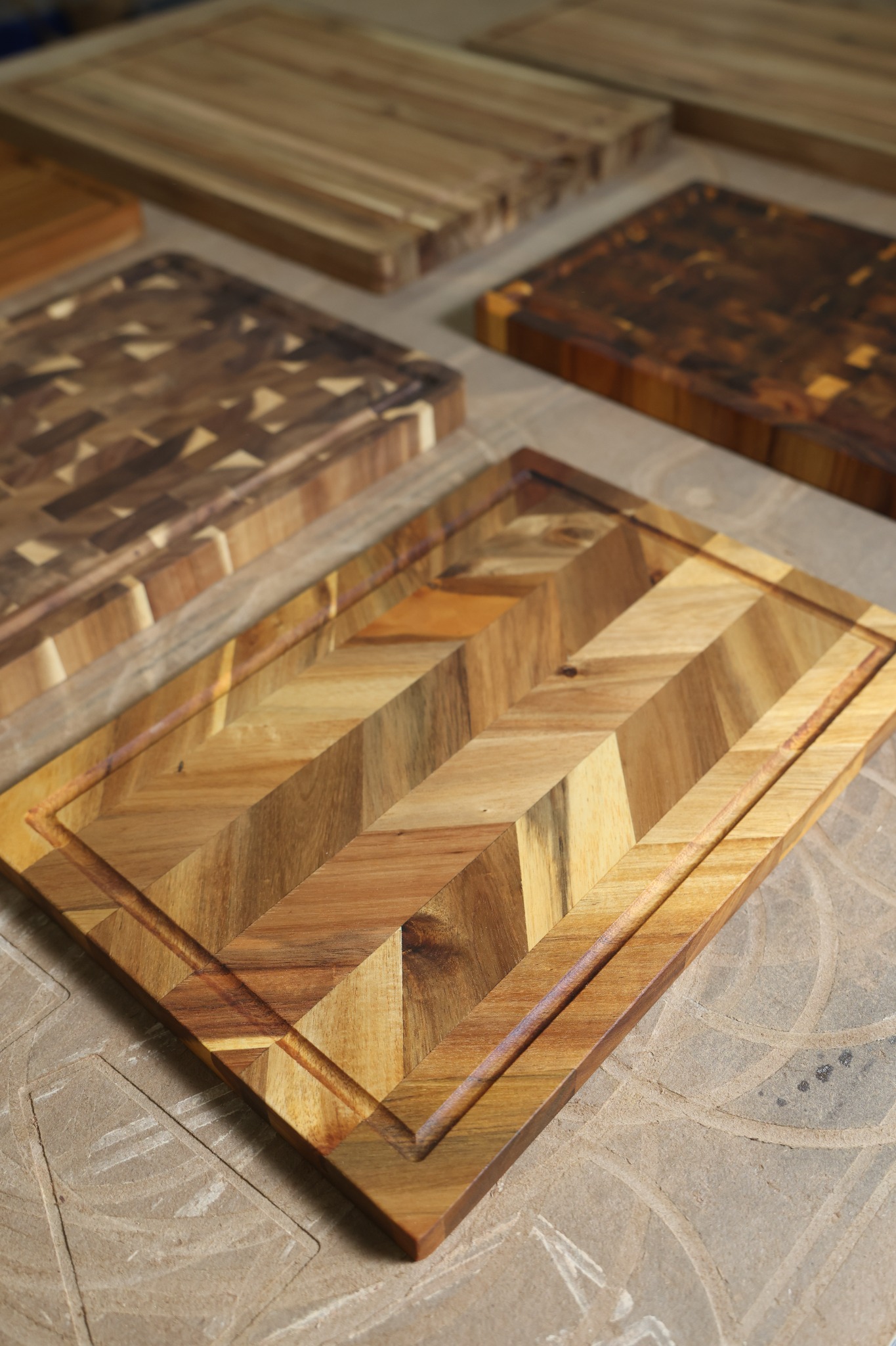 Close-up of a chevron-pattern wooden board and routed juice groove