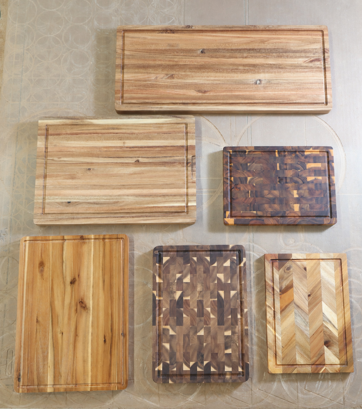 Six wooden cutting boards made in Vietnam, with straight-grain, end-grain and chevron designs and full perimeter juice grooves