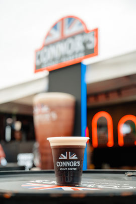 Branded Connor’s coffee cup on event display table