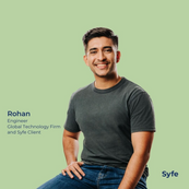 Relaxed business profile portrait of male client in grey tee on teal background