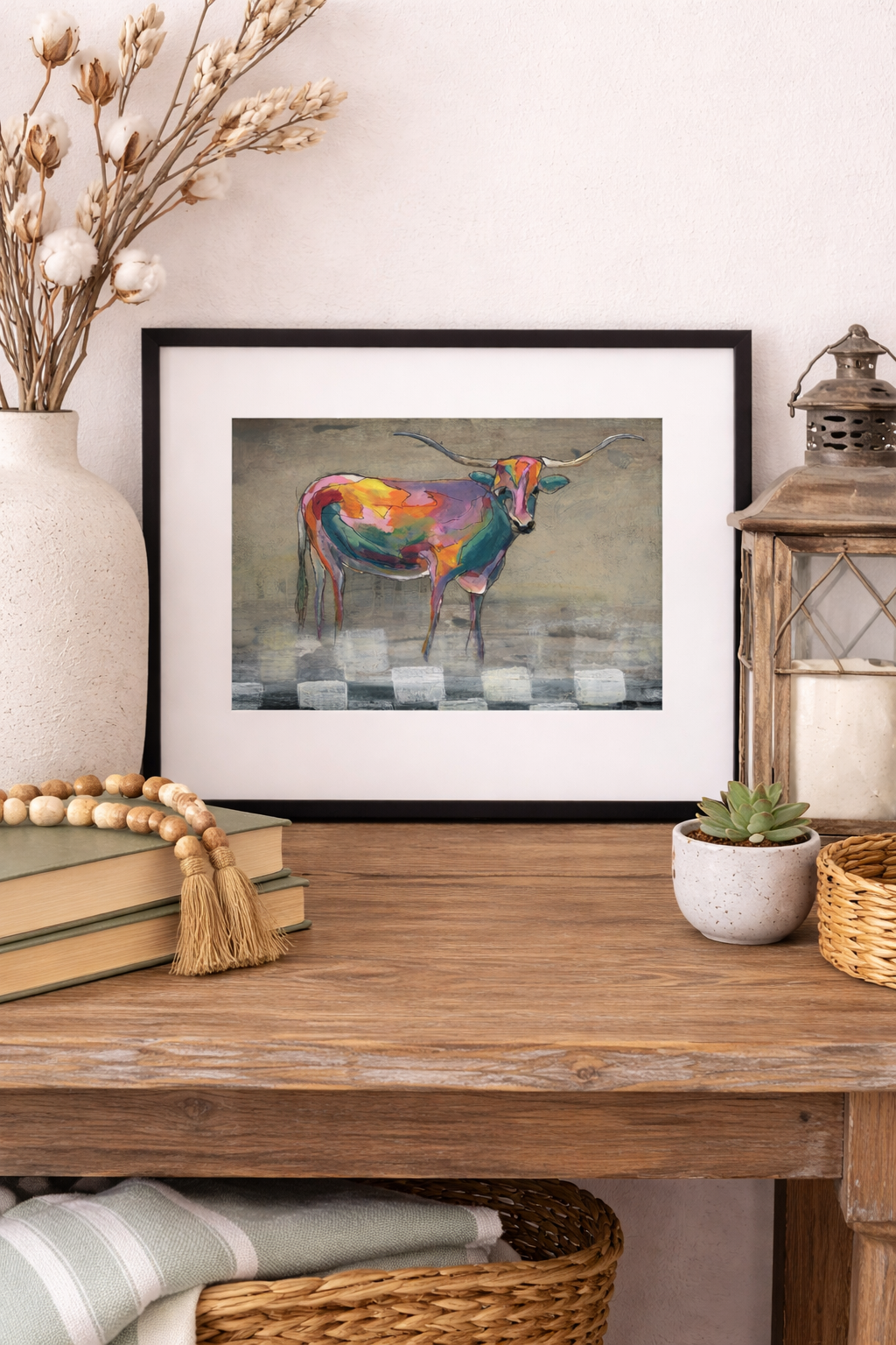 Neon Rancher horizontal mini print in a black 8x10 frame with white mat, styled on a rustic western wood console with cotton