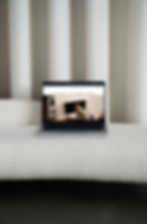 Thumbnail: Clean Wix template mockup on a laptop on a white sofa chaise