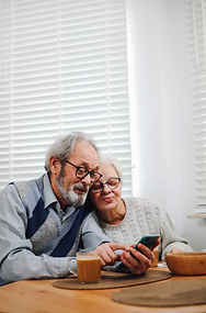 Happy Old Couple Using Mobile Phone Together