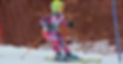 9 year old girl in race suit skiing a slalom course