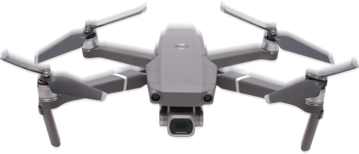 Gray drone with propellers, camera, and body details, ready to fly outdoors