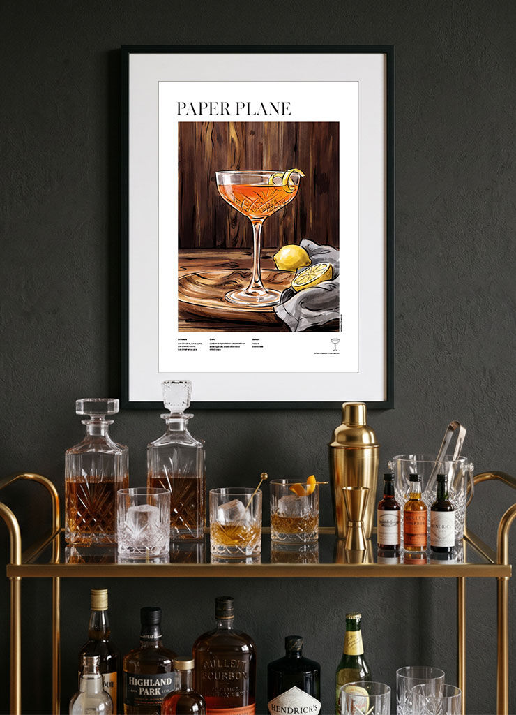 Paper Plane — illustrated cocktail recipe poster displayed in modern home bar interior