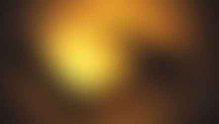 Closed black hardcover book on a warm golden table, lit dramatically with a moody glow.