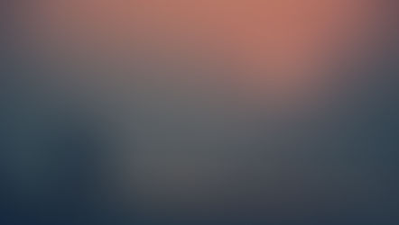 Silhouetted person carrying a child on a beach at sunset, with calm waves and an orange sun over a misty sea.