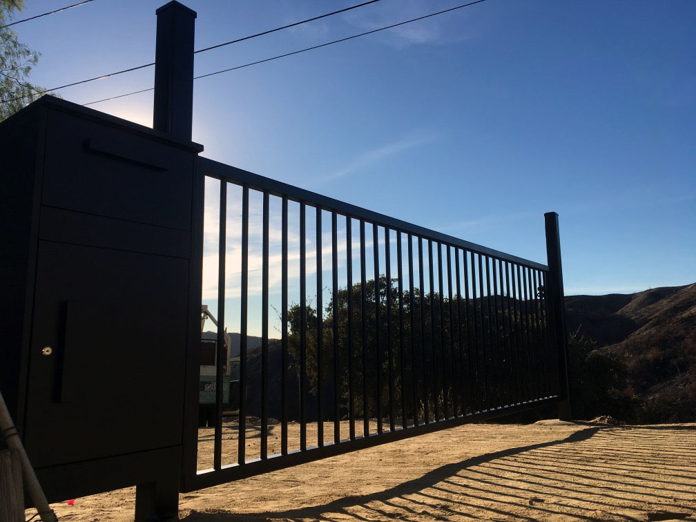 Black iron fence and gate along a hillside property overlooking the foothills in Tujunga, CA