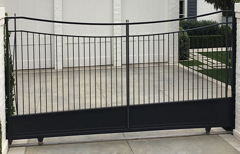 Reverse arch wrought iron gate with double top rail and solid sheet metal kick plate By The Gatekeeper