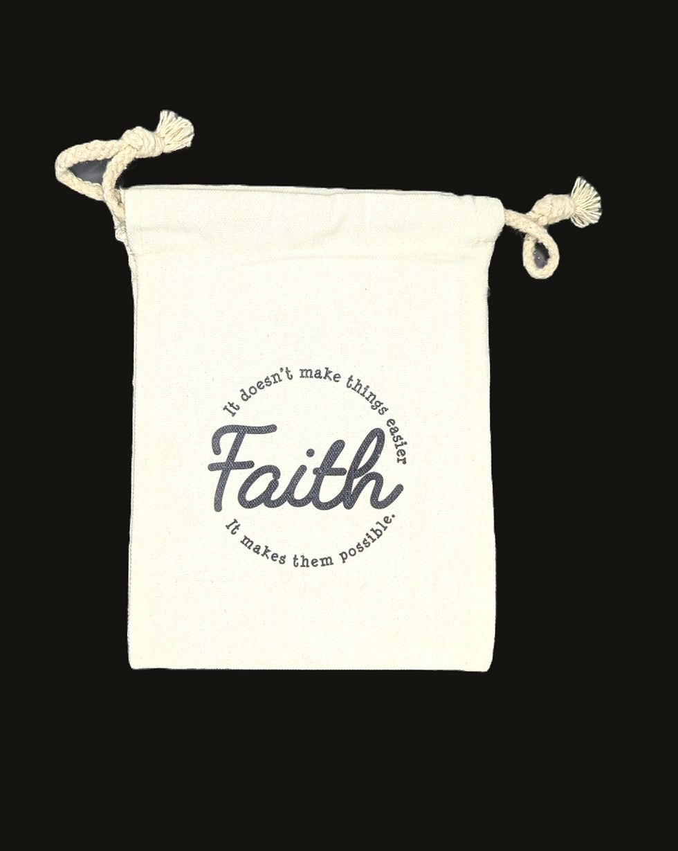 Small, white drawstring bag with text printed on it that reads: Faith. It doesn't make things easier, it makes them possible.