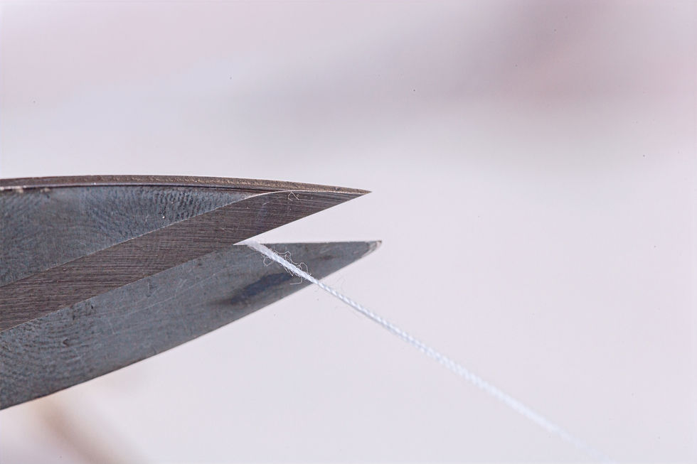 The scissors slicing through the cord represent the conscious act of freeing oneself from unhealthy energetic ties and embracing emotional liberation.