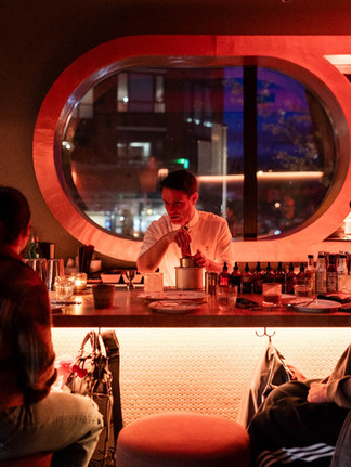 A bartender serving drinks at June